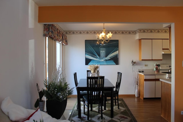 dining space with a chandelier and dark hardwood / wood-style floors