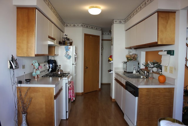 kitchen featuring white cabinets, hardwood / wood-style floors, white appliances, and sink