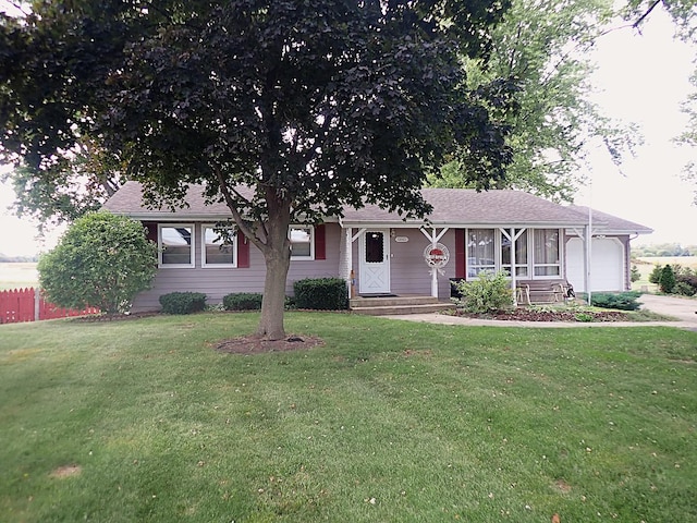 single story home with a garage and a front lawn