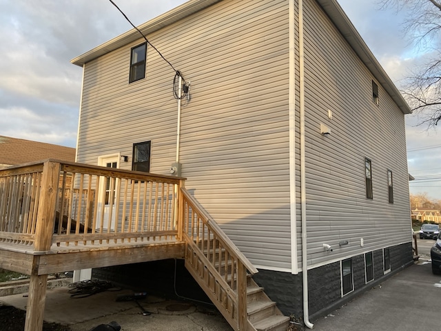 view of property exterior with a wooden deck