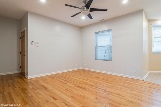 spare room featuring light wood-type flooring and ceiling fan