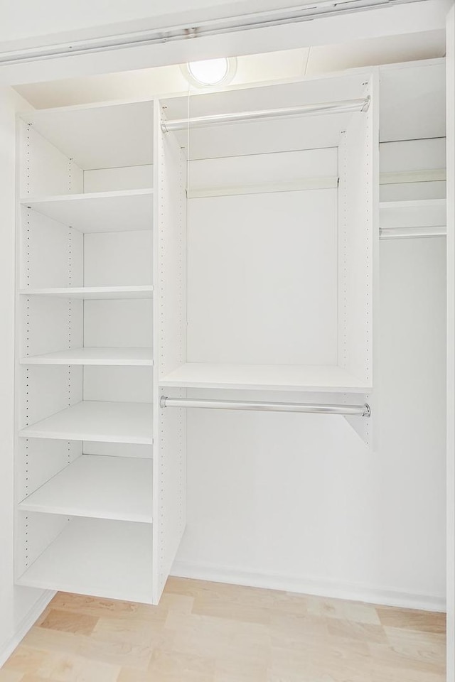 spacious closet with light hardwood / wood-style floors