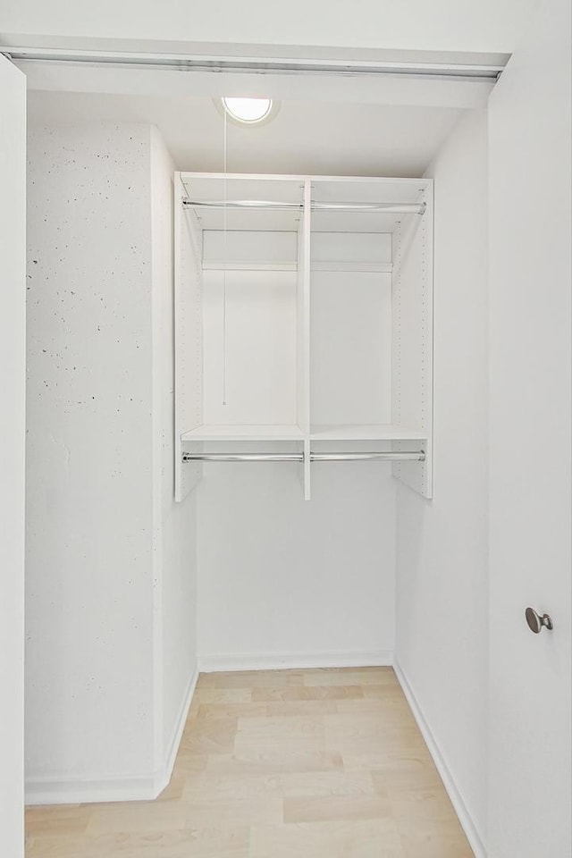 spacious closet with light hardwood / wood-style floors