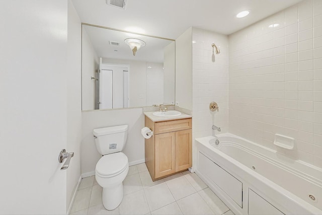 full bathroom with vanity, tile patterned floors, tiled shower / bath combo, and toilet