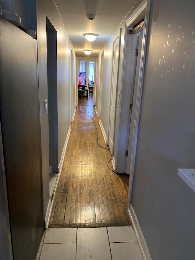 corridor with light hardwood / wood-style floors