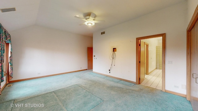 carpeted empty room with ceiling fan and lofted ceiling