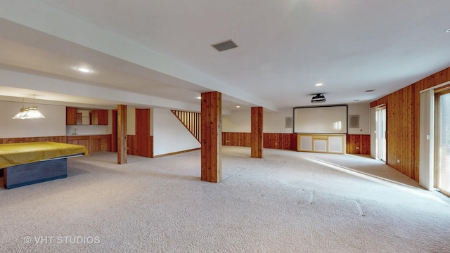 basement featuring wood walls, light colored carpet, and pool table