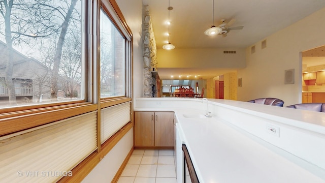 kitchen with ceiling fan, light tile patterned floors, and sink