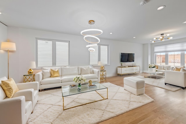 living room with light hardwood / wood-style flooring and a chandelier