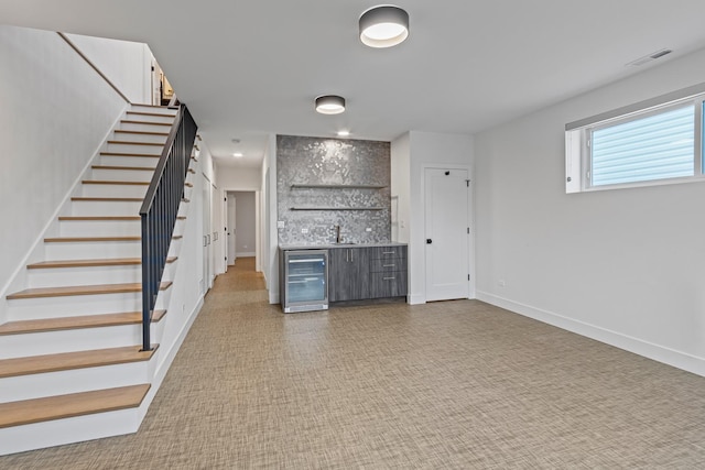 interior space featuring wine cooler and indoor wet bar