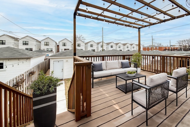 wooden terrace with outdoor lounge area, a pergola, and a shed