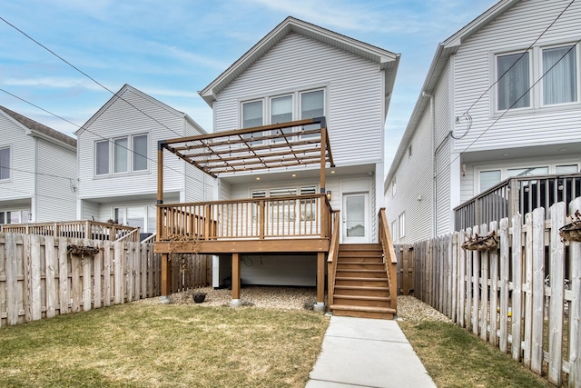 back of house featuring a pergola, a wooden deck, and a yard