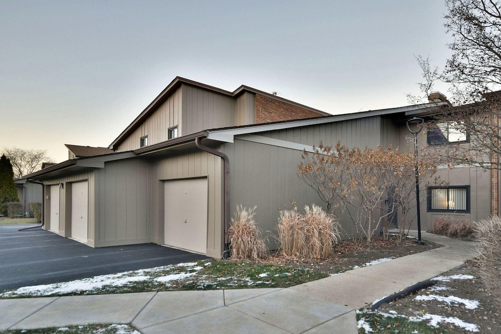 property exterior at dusk with a garage