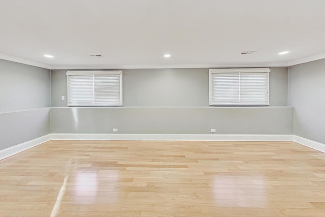 spare room with light hardwood / wood-style floors and ornamental molding