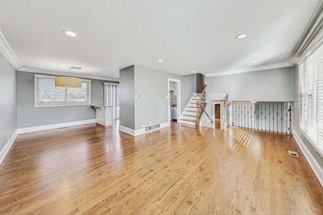 unfurnished living room featuring wood-type flooring and crown molding