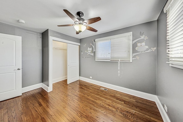 unfurnished bedroom featuring a closet, ceiling fan, and hardwood / wood-style floors