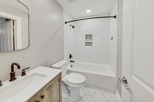 full bathroom featuring tile patterned floors, vanity, toilet, and tiled shower / bath