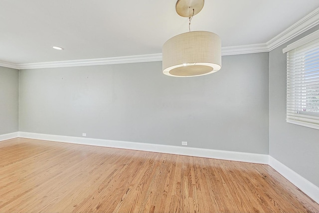 unfurnished room featuring hardwood / wood-style floors and crown molding