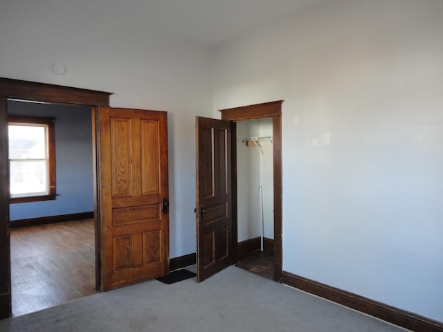 unfurnished bedroom with dark colored carpet