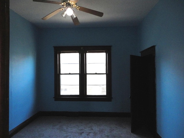 empty room with carpet flooring and ceiling fan