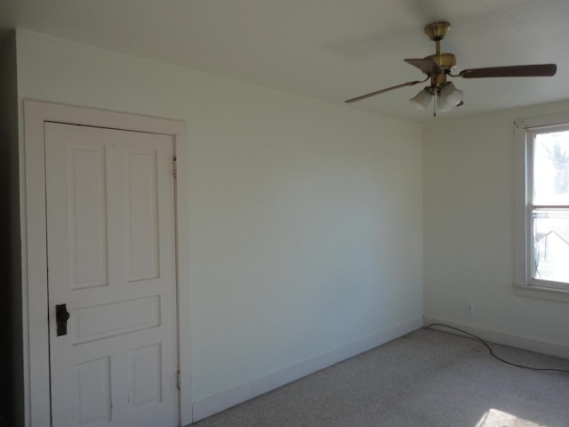 carpeted empty room with ceiling fan