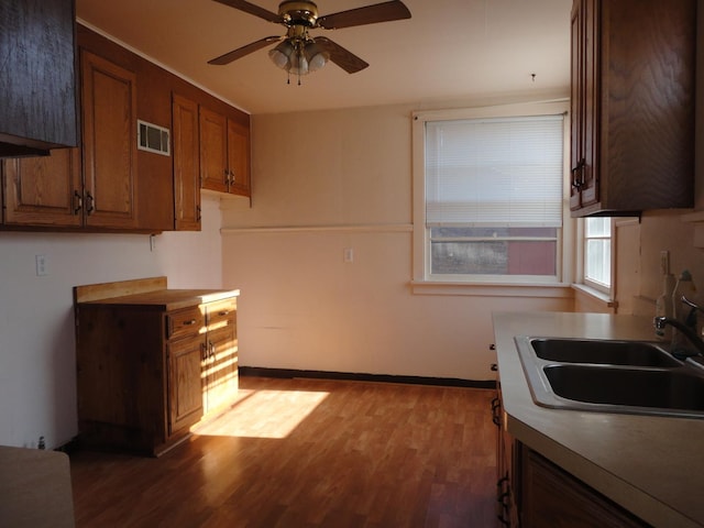 kitchen with ceiling fan, dark hardwood / wood-style flooring, and sink