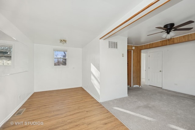 spare room with light hardwood / wood-style floors, ceiling fan, and a healthy amount of sunlight