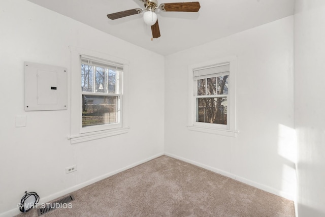 carpeted empty room featuring electric panel and ceiling fan