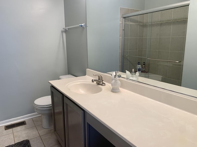 bathroom with toilet, vanity, tile patterned floors, and walk in shower