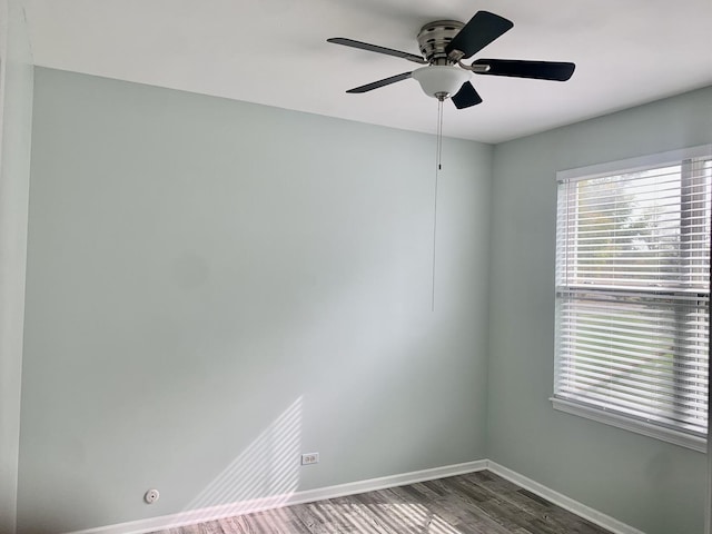 empty room featuring ceiling fan and dark wood-type flooring