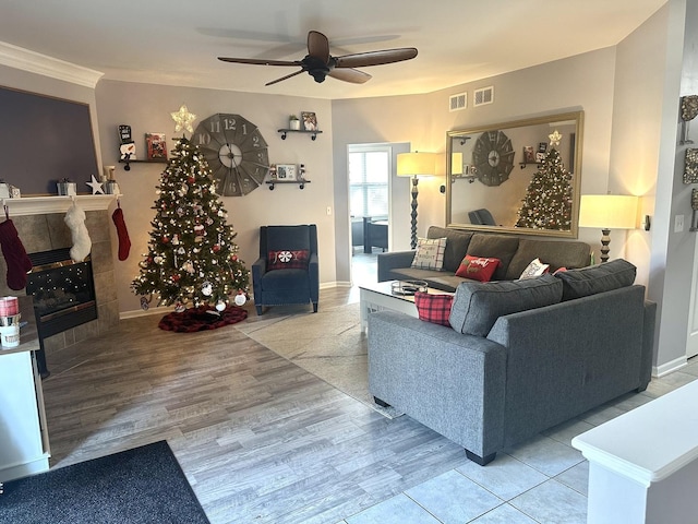 living room with ceiling fan, light hardwood / wood-style floors, and crown molding