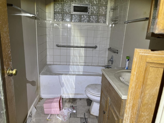 full bathroom with tiled shower / bath, vanity, and toilet