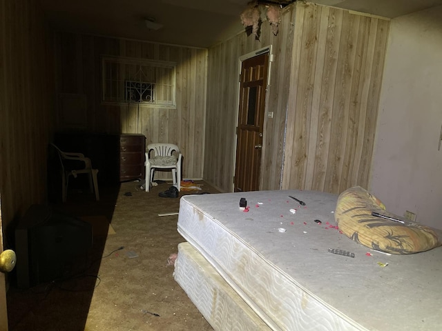 bedroom featuring wooden walls