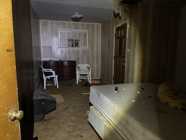 bedroom featuring wood walls