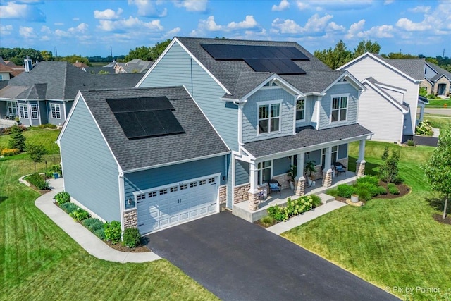 craftsman house featuring solar panels, a porch, and a front lawn