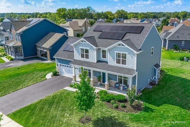 craftsman-style home with central air condition unit, a porch, a front yard, and solar panels