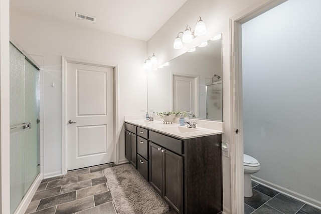 bathroom featuring vanity, toilet, a shower with shower door, and a chandelier