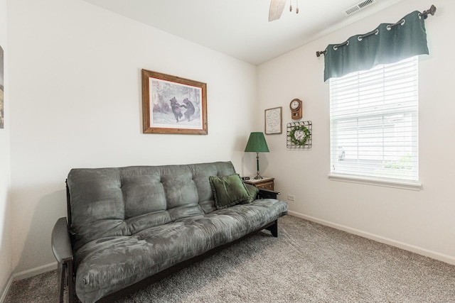 carpeted living room featuring ceiling fan