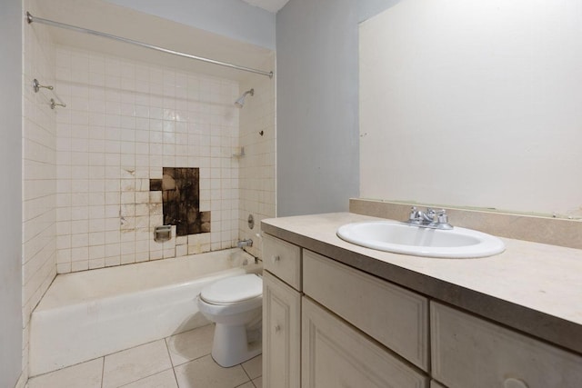 full bathroom featuring tile patterned flooring, vanity, tiled shower / bath combo, and toilet