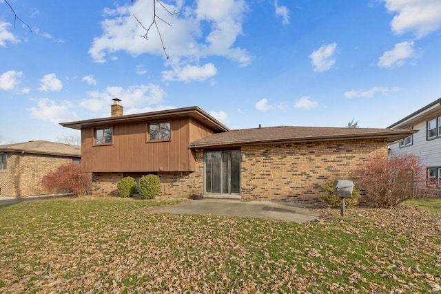 rear view of property featuring a patio area and a yard