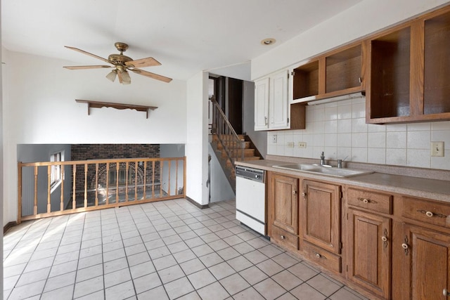 kitchen featuring backsplash, white dishwasher, ceiling fan, sink, and light tile patterned floors