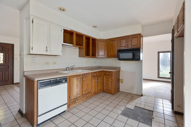 kitchen featuring tasteful backsplash, light carpet, dishwasher, and sink