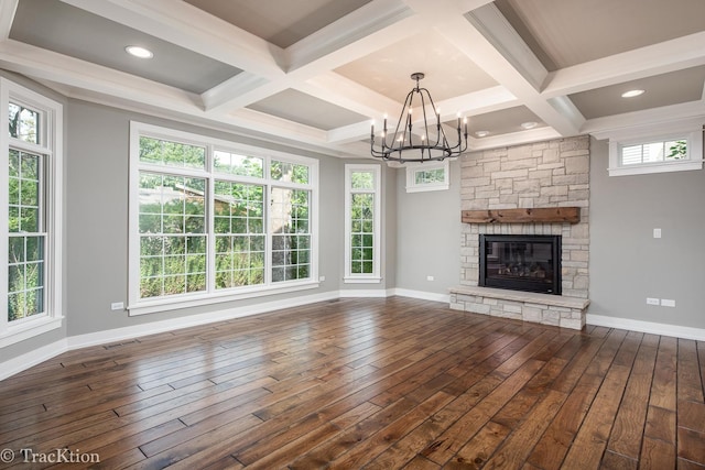 unfurnished living room with beam ceiling, a fireplace, dark wood-type flooring, and coffered ceiling