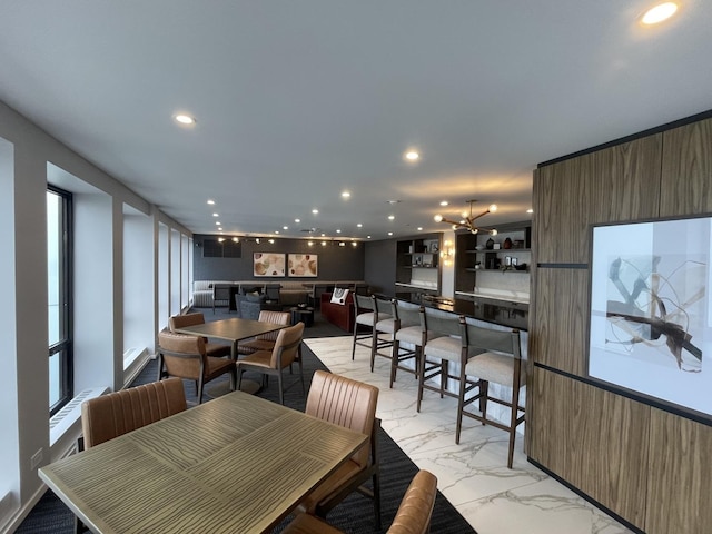 dining space with an inviting chandelier