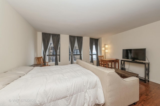 bedroom with dark wood-type flooring