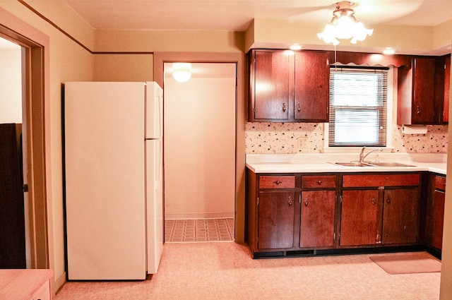 kitchen featuring white refrigerator and sink