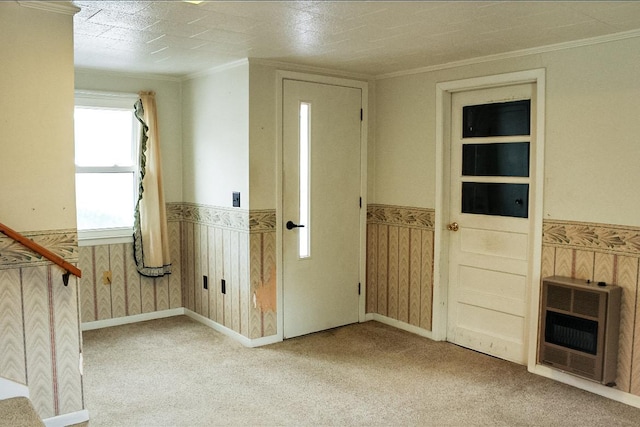 foyer with a textured ceiling, crown molding, light carpet, and heating unit