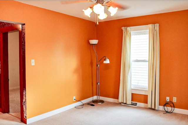 carpeted empty room with ceiling fan