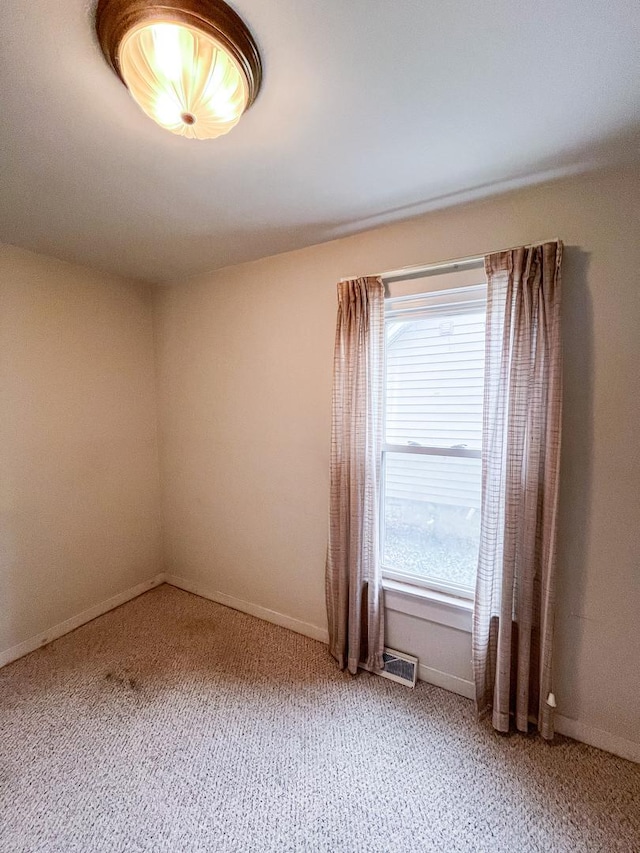 spare room featuring carpet floors