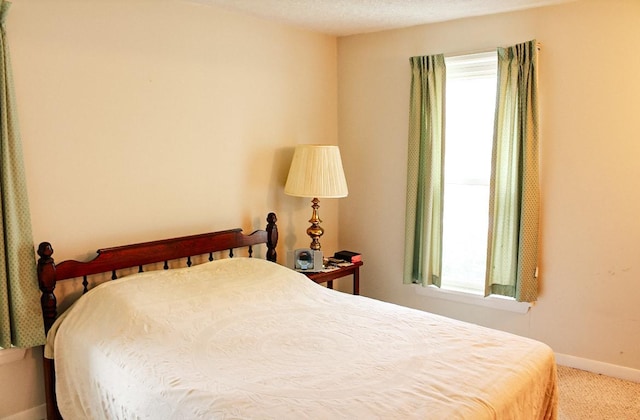 bedroom featuring carpet floors and a textured ceiling